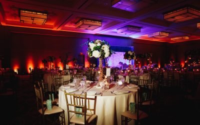 Decorated banquet hall with served round table with hydrangea centerpiece and chiavari chairs